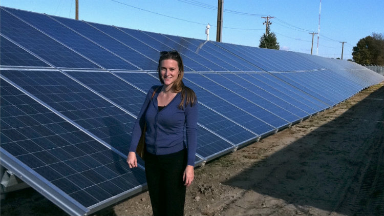 Tess O’Brien in a solar energy field. Tess O’Brien in a solar energy field.